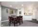 Inviting dining area with a wooden table and seating, adjacent to the kitchen and living spaces at 18242 E Bethany Pl, Aurora, CO 80013