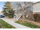 Exterior view of home showcasing landscaped front yard and inviting entrance staircase at 18242 E Bethany Pl, Aurora, CO 80013