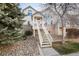 Charming home featuring a welcoming front entrance with white stairs and landscaped surroundings at 18242 E Bethany Pl, Aurora, CO 80013