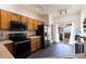 Modern kitchen with black appliances, plenty of storage, and direct access to an outdoor patio at 18242 E Bethany Pl, Aurora, CO 80013