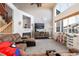 Bright living room featuring high ceilings, large windows, and comfortable seating around a fireplace at 18242 E Bethany Pl, Aurora, CO 80013