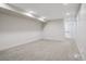 Spacious, unfinished basement with neutral carpet and plenty of room for activities at 1386 Zenobia St, Denver, CO 80204