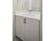 Bathroom vanity with white countertop and wood finish cabinets at 1386 Zenobia St, Denver, CO 80204