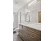 Modern bathroom vanity with a glass-enclosed shower and tile floor at 1386 Zenobia St, Denver, CO 80204