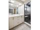 Bright bathroom with a double sink vanity, modern fixtures and walk-in shower at 1386 Zenobia St, Denver, CO 80204
