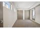 A bright bedroom features neutral carpeting, dual closets, and a private balcony entrance for a serene retreat at 1386 Zenobia St, Denver, CO 80204