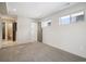 Bright carpeted bedroom features ensuite bath, large window, and neutral decor, creating a comfortable and inviting space at 1386 Zenobia St, Denver, CO 80204