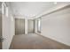A bright bedroom features neutral carpeting, dual closets, and a private balcony entrance for a serene retreat at 1386 Zenobia St, Denver, CO 80204