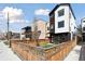 Modern home with wood and white exterior, plus a lawn and wooden fence at 1386 Zenobia St, Denver, CO 80204