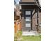 Front door with sidelights and modern address numbers on wood exterior at 1386 Zenobia St, Denver, CO 80204