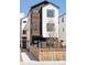 Modern home with wood and white exterior, plus a lawn and wooden fence at 1386 Zenobia St, Denver, CO 80204
