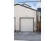 A standalone white garage with a black trim and concrete foundation at 1386 Zenobia St, Denver, CO 80204