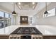 Open concept kitchen with modern gas cooktop island overlooking the bright living area, enhancing the home's flow at 1386 Zenobia St, Denver, CO 80204