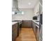 Gourmet kitchen featuring modern appliances, designer cabinetry, and hardwood floors for a sophisticated look at 1386 Zenobia St, Denver, CO 80204
