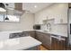 Modern kitchen with sleek cabinetry, stainless steel appliances, and a gas cooktop on a spacious white countertop at 1386 Zenobia St, Denver, CO 80204