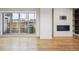 Living space with a sleek fireplace, access to an outdoor patio, and hardwood flooring at 1386 Zenobia St, Denver, CO 80204