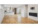 Living room and kitchen with stainless steel appliances and a fireplace at 1386 Zenobia St, Denver, CO 80204