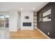 Bright living room featuring a modern fireplace, shelving and access to backyard at 1386 Zenobia St, Denver, CO 80204