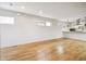 Bright living room featuring hardwood floors, recessed lighting, and neutral paint, adjoining the kitchen with sleek countertops at 1386 Zenobia St, Denver, CO 80204