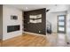 Living room with fireplace, hardwood floors and a modern-style front door at 1386 Zenobia St, Denver, CO 80204