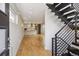 Open-concept living space with wood floors and stairs with metal railing at 1386 Zenobia St, Denver, CO 80204