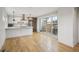 Open concept living area with hardwood floors and glass doors leading to an outdoor space with a barbecue grill at 1386 Zenobia St, Denver, CO 80204