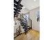 Modern staircase with steel railings and natural wood treads, offering an airy and contemporary design at 1386 Zenobia St, Denver, CO 80204