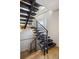 Modern staircase with steel railings and natural wood treads, offering an airy and contemporary design at 1386 Zenobia St, Denver, CO 80204
