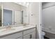 Bathroom featuring double sinks with quartz countertops and shower over tub at 13920 Hanging Lake St, Parker, CO 80138