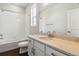 Bright bathroom featuring a shower over bath, a large mirror, and a granite vanity at 13920 Hanging Lake St, Parker, CO 80138