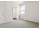 Neutral bedroom featuring carpet flooring and doorway access to a bathroom at 13920 Hanging Lake St, Parker, CO 80138