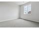 Bright bedroom with plush carpeting and a large window offering ample natural light at 13920 Hanging Lake St, Parker, CO 80138
