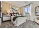 Comfortable bedroom with neutral tones, decorative headboard and large window for natural light at 13920 Hanging Lake St, Parker, CO 80138