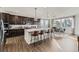 Modern kitchen featuring dark cabinetry, quartz countertops, a large island, and stainless appliances at 13920 Hanging Lake St, Parker, CO 80138