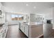 Bright kitchen features an island with sink, modern appliances, and light wood floors at 13920 Hanging Lake St, Parker, CO 80138