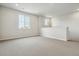 Neutral loft featuring carpet flooring and windows offering neighborhood views at 13920 Hanging Lake St, Parker, CO 80138