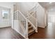 A staircase with carpeted treads and painted white risers and railings connects upper floors at 13920 Hanging Lake St, Parker, CO 80138