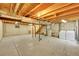 Unfinished basement with exposed beams and concrete floor at 9930 W Progress Pl, Littleton, CO 80123