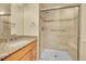 Tiled bathroom featuring a granite vanity, sink, and glass-enclosed shower at 9930 W Progress Pl, Littleton, CO 80123