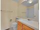 Bathroom with single sink vanity, toilet, and shower over tub at 9930 W Progress Pl, Littleton, CO 80123