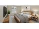 Nicely decorated bedroom features a bed with nightstands, lamps, potted plant, and artwork at 9930 W Progress Pl, Littleton, CO 80123