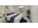 A stylish bedroom with a large bed, modern decor, and ample natural light for comfortable living at 9930 W Progress Pl, Littleton, CO 80123