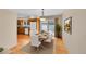 Warm dining room features hardwood floors, a dining table, and kitchen access at 9930 W Progress Pl, Littleton, CO 80123
