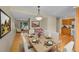 Dining room with seating for six, chandelier lighting, and view into the living room at 9930 W Progress Pl, Littleton, CO 80123