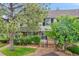 Attractive townhouse featuring a well-maintained lawn and mature trees for added curb appeal and privacy at 9930 W Progress Pl, Littleton, CO 80123
