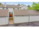 Charming townhome exterior featuring well-maintained garages with a beautiful, earthy-toned roof and siding at 9930 W Progress Pl, Littleton, CO 80123
