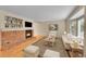 Bright living room with hardwood floors, brick fireplace, and neutral-toned furniture at 9930 W Progress Pl, Littleton, CO 80123