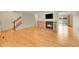 Open-concept living room with hardwood floors and a brick fireplace at 9930 W Progress Pl, Littleton, CO 80123
