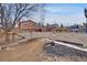 Large backyard with rock landscaping, wood deck, detached shed, and privacy fence at 1301 S Yampa Ct, Aurora, CO 80017