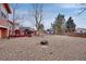 Spacious backyard with rock landscaping, wood deck, and a fire pit provides a relaxing outdoor oasis at 1301 S Yampa Ct, Aurora, CO 80017